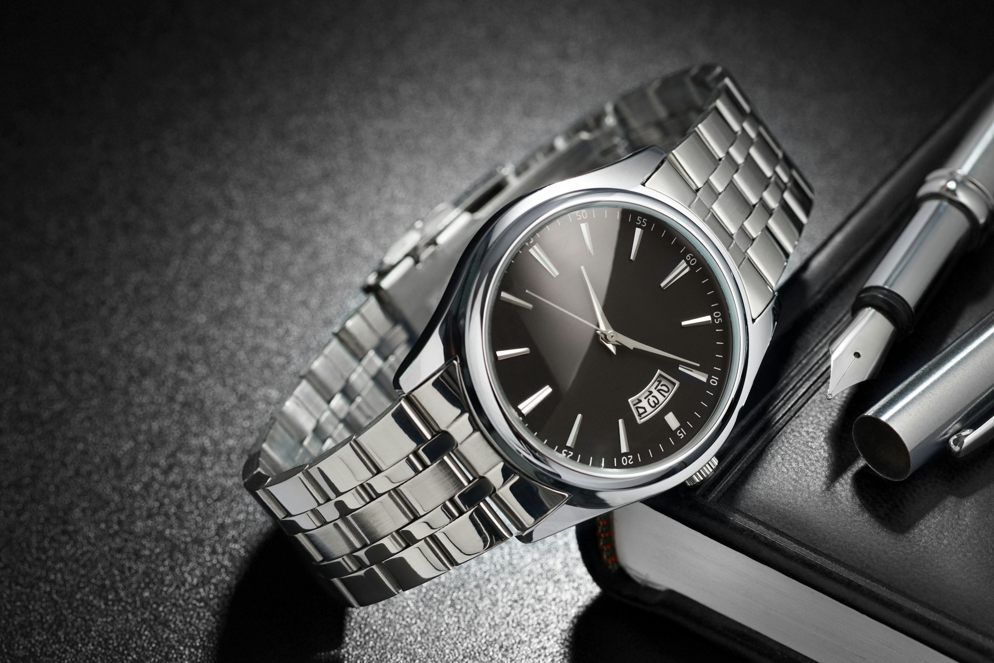 Steel wristwatch on black background